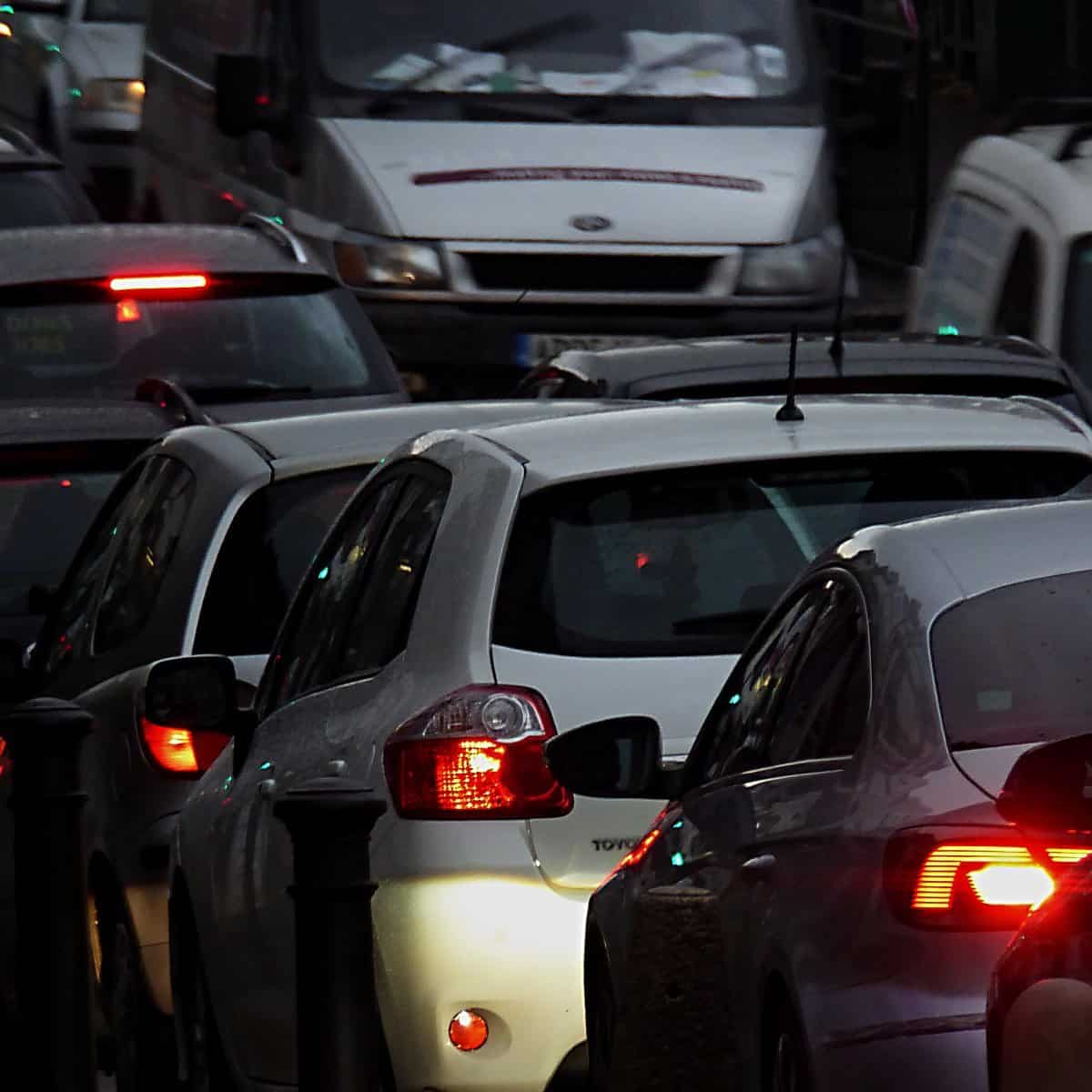 A colour photo of cars stuck in traffic at night